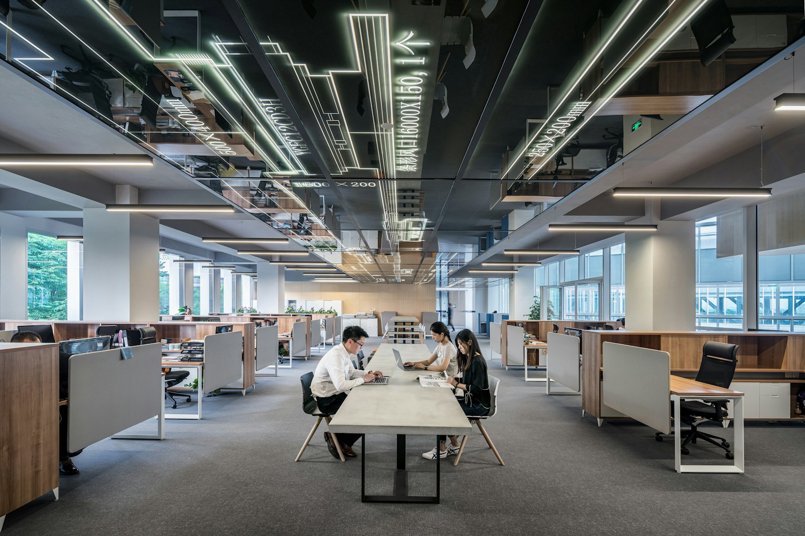 Modern open-plan office with people collaborating at a table