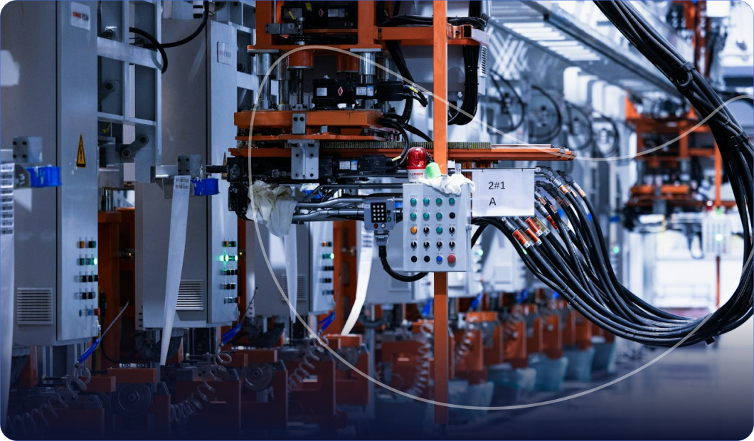 Industrial factory floor with orange machinery and cables